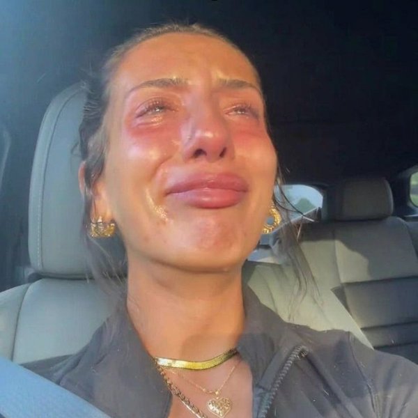 Woman crying alone in her car after the hairdresser told her the truth about her hair loss